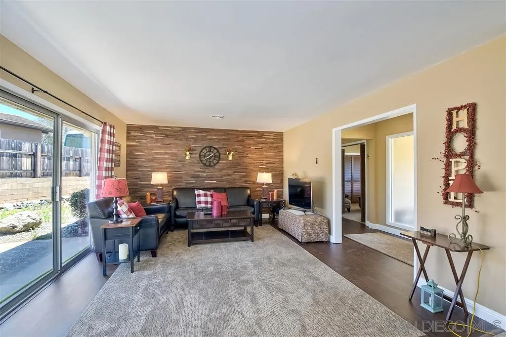 1651 Highlands View Road Alpine, CA 91901 - Photo 5 of 25 a living room with furniture a flat screen tv and a fireplace