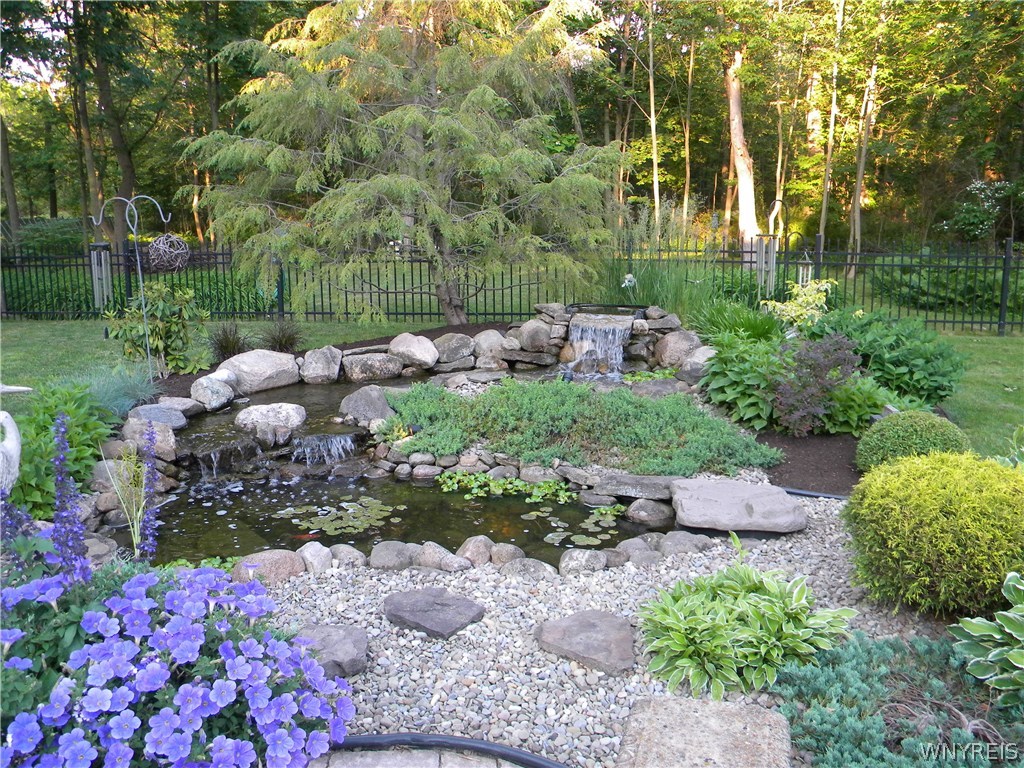 4535 Lower River Road Lewiston, NY 14092 - Photo 31 of 32 Pond with multiple waterfalls and koi fish in a fu
