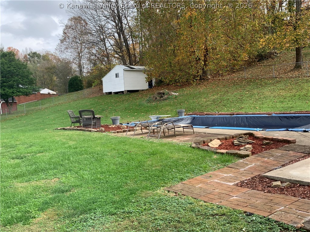 357 Charleston Road Point Pleasant, WV 25550 - Photo 19 of 21 View of the back yard showing the pool closed for the season and a storage building at the back corner