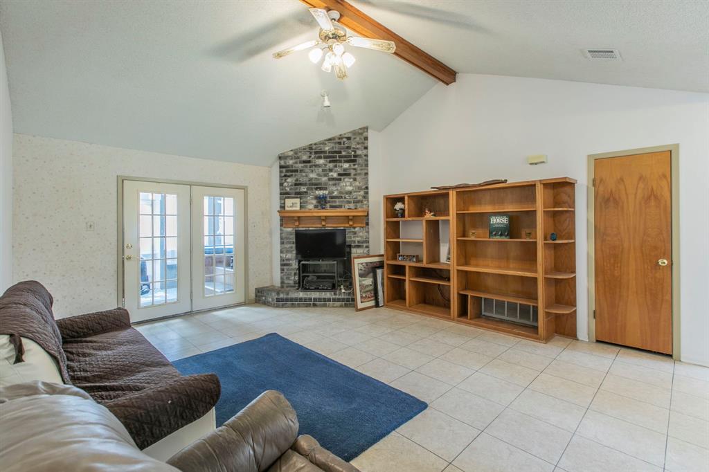 1936 Post Oak Drive Waco, TX 76705 - Photo 5 of 33 Living room with light tile patterned floors, a fireplace, and a ceiling fan