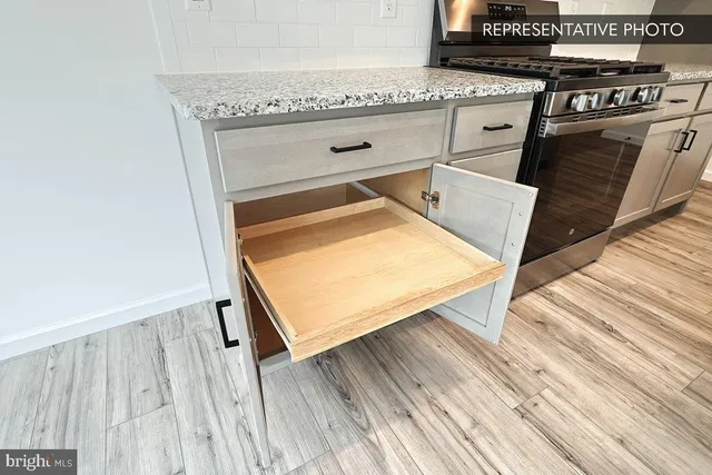 a view of kitchen with sink and wooden floor