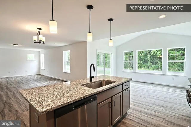 a kitchen with center island wooden floor and a chandelier