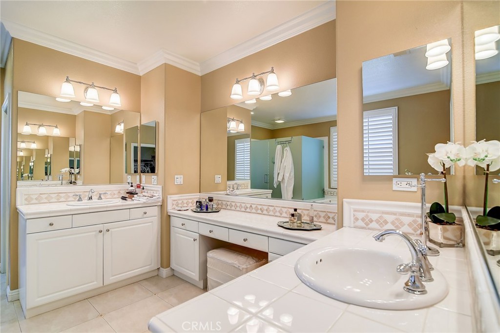 47 Snowdrop Tree Irvine, CA 92606 - Photo 11 of 29 a bathroom with a double vanity sink and a mirror