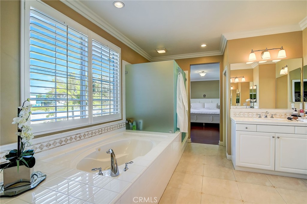 47 Snowdrop Tree Irvine, CA 92606 - Photo 12 of 29 a spacious bathroom with a tub sink and mirror