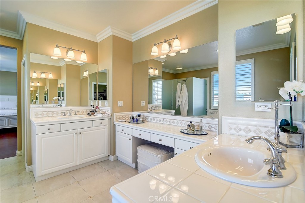 47 Snowdrop Tree Irvine, CA 92606 - Photo 13 of 29 a bathroom with a double vanity sink mirror and