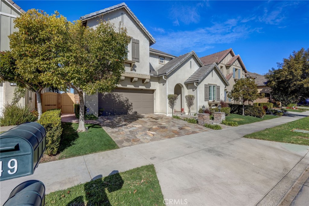 47 Snowdrop Tree Irvine, CA 92606 - Photo 20 of 29 a front view of a house with a yard and garage