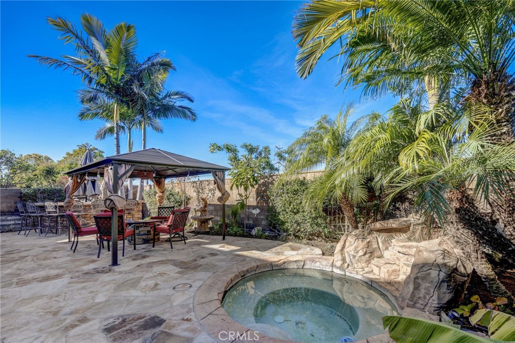 47 Snowdrop Tree Irvine, CA 92606 - Photo 24 of 29 a couple of table and chairs under an umbrella