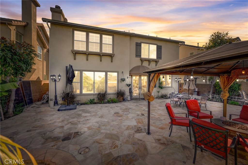 47 Snowdrop Tree Irvine, CA 92606 - Photo 29 of 29 a patio with table and chairs and potted plants
