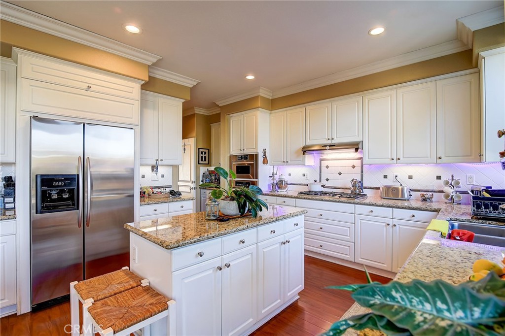 47 Snowdrop Tree Irvine, CA 92606 - Photo 3 of 29 a kitchen with stainless steel appliances granite countertop a refrigerator sink and cabinets