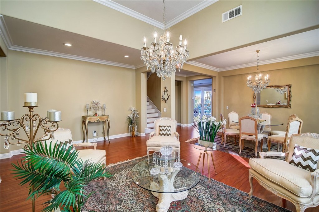 47 Snowdrop Tree Irvine, CA 92606 - Photo 5 of 29 a living room with fireplace furniture and a chandelier