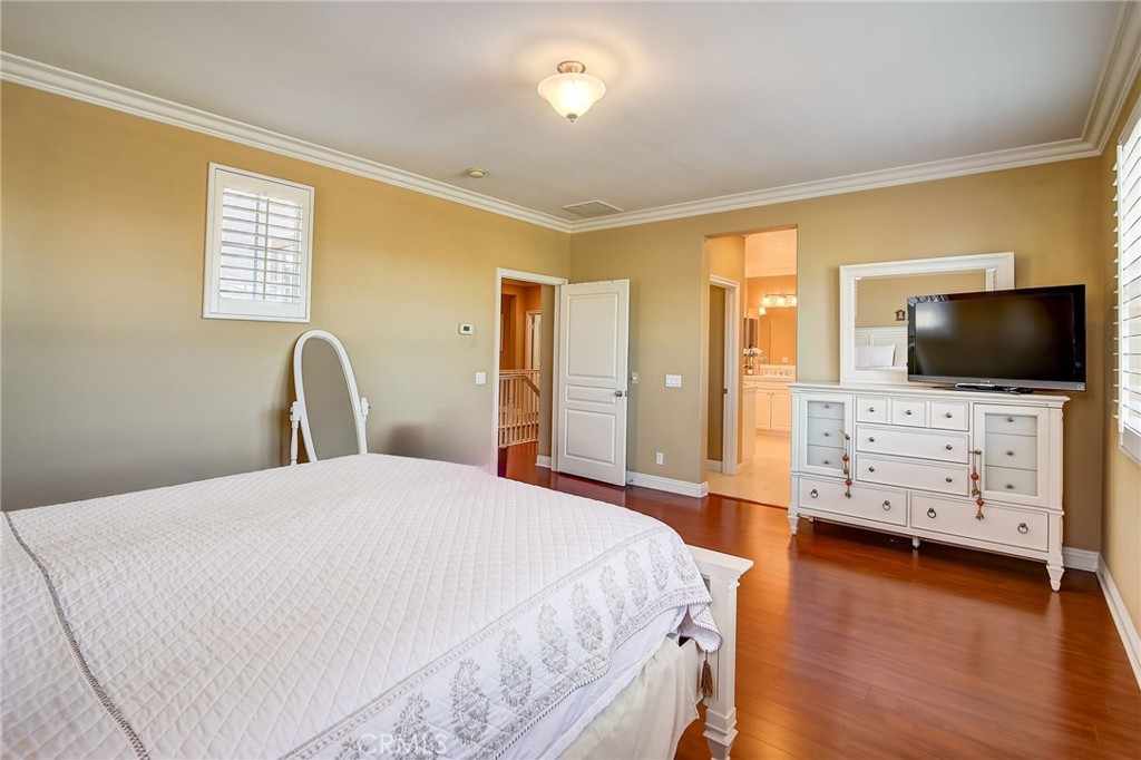 47 Snowdrop Tree Irvine, CA 92606 - Photo 9 of 29 a bedroom with a bed and flat screen tv