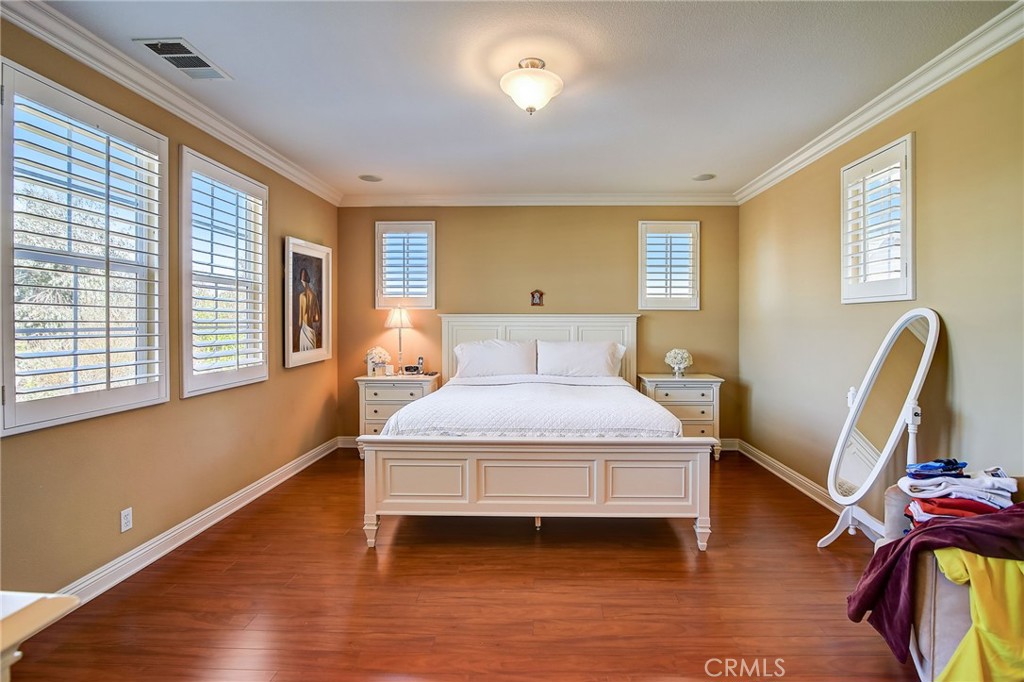 47 Snowdrop Tree Irvine, CA 92606 - Photo 10 of 29 a bedroom with a bed wooden floor and window