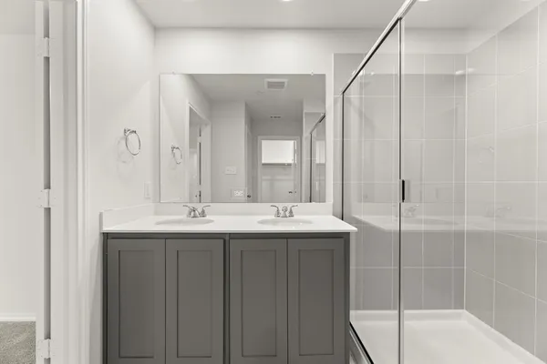 a bathroom with double sink and mirror