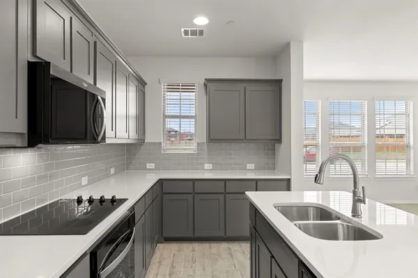 a kitchen that has a sink and a stove
