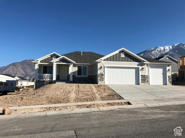 1447 North 1350 E Street, Unit 5 Mapleton, UT 84664 - Photo 7 of 10 Craftsman house with board and batten siding, a mountain view, stone siding, and concrete driveway