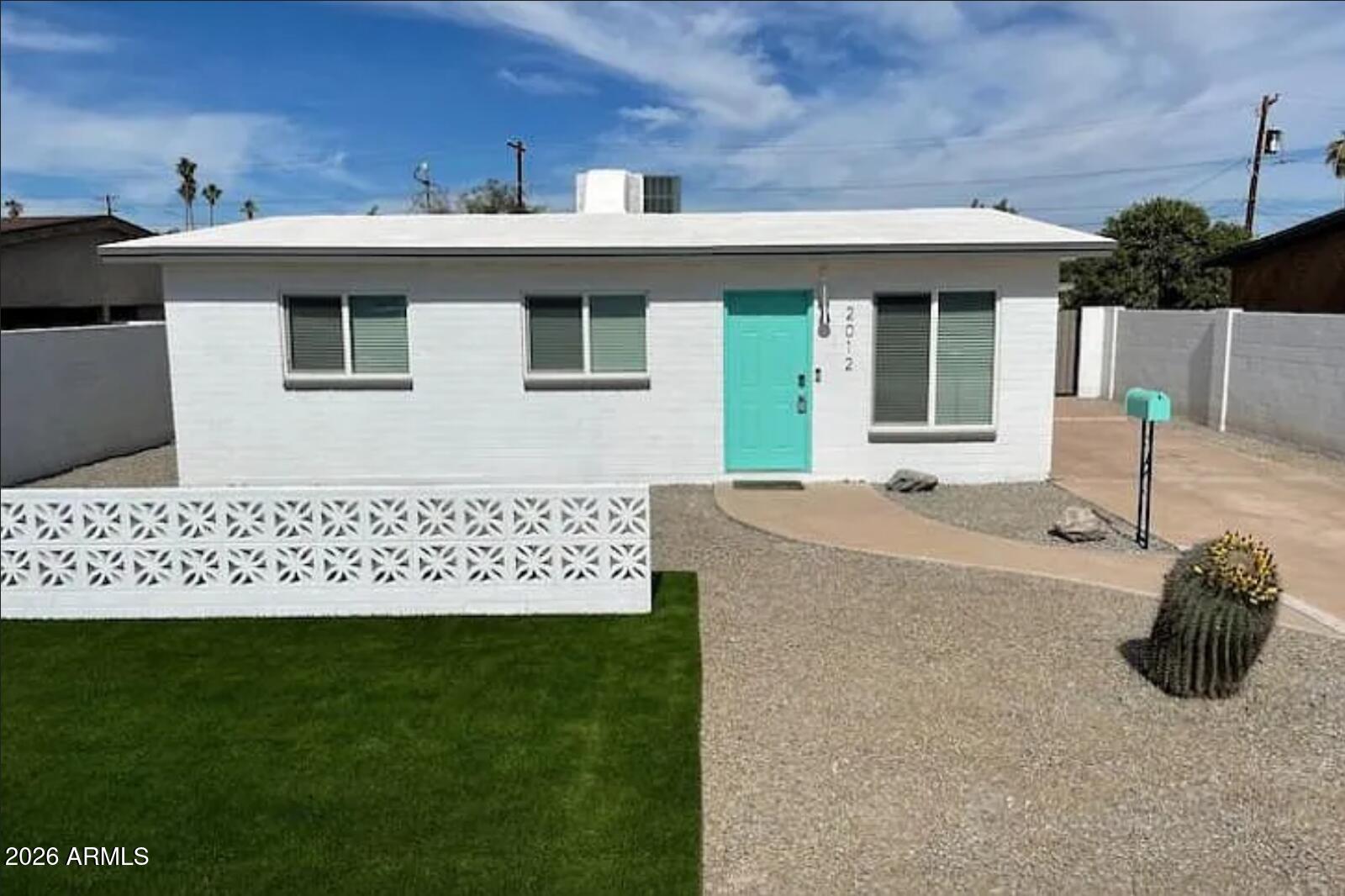 a view of a house with a backyard and a porch