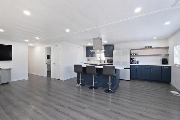 a view of kitchen with refrigerator microwave and wooden floor