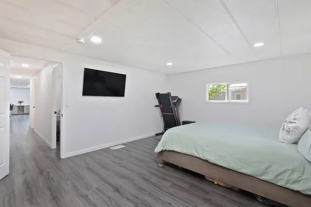 a bedroom with a bed and a flat screen tv