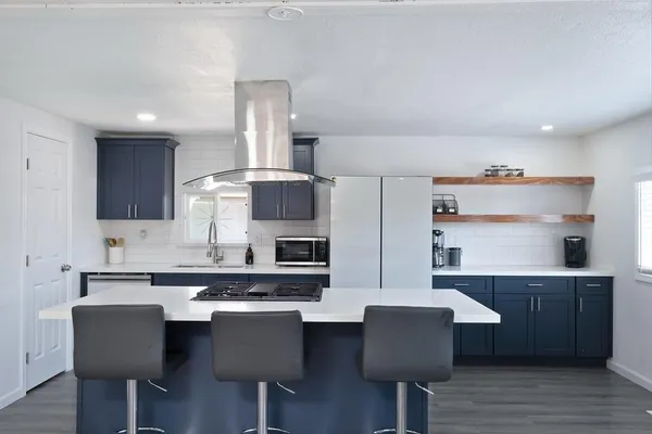 a kitchen with a table chairs sink and cabinets
