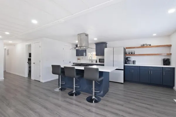 a kitchen with a sink cabinets and wooden floor