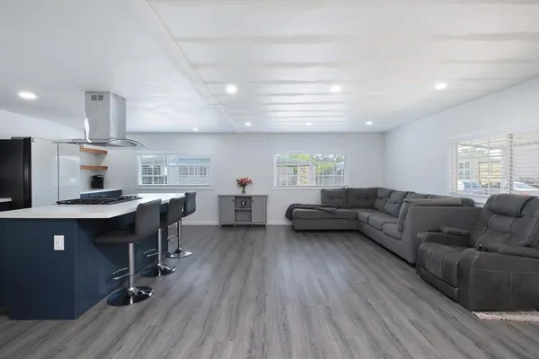 a living room with furniture and a wooden floor