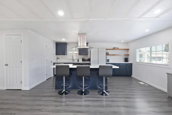 a kitchen with a sink cabinets and wooden floor