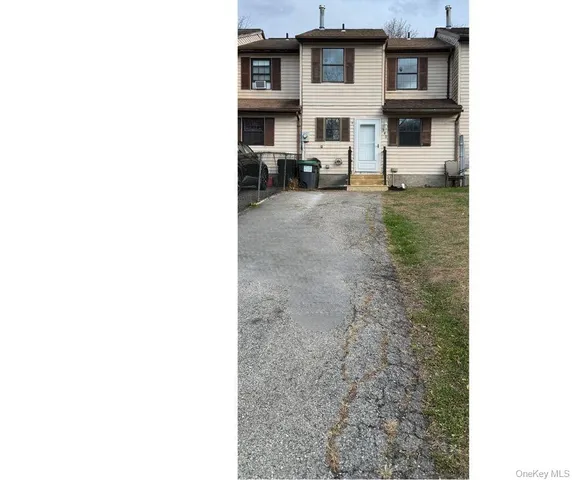 a view of a house with a backyard and a table