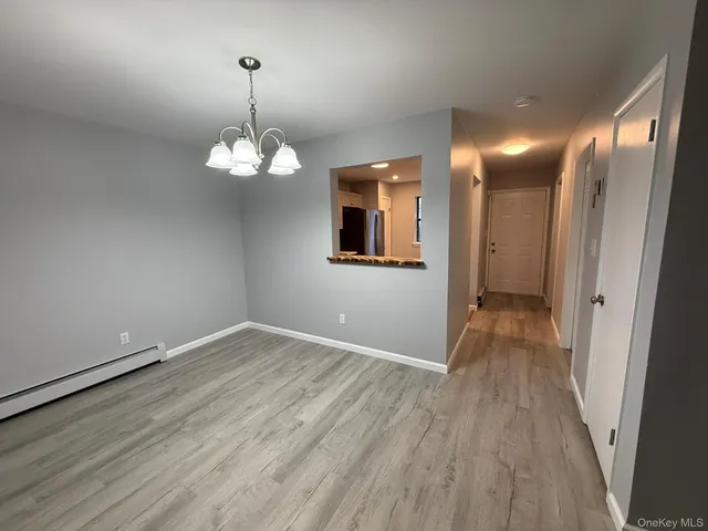 a view of a room with wooden floor and staircase