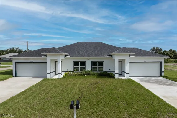 a front view of a house with a garden