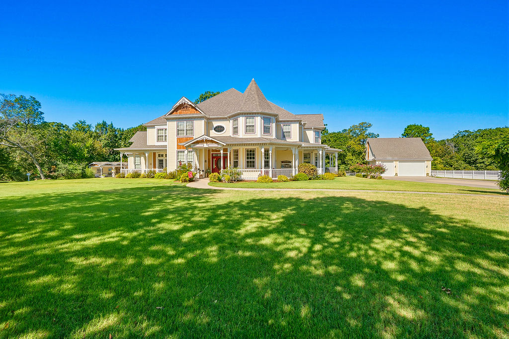 Victorian-style residence featuring a turret, wrap-around porch, and gable roof