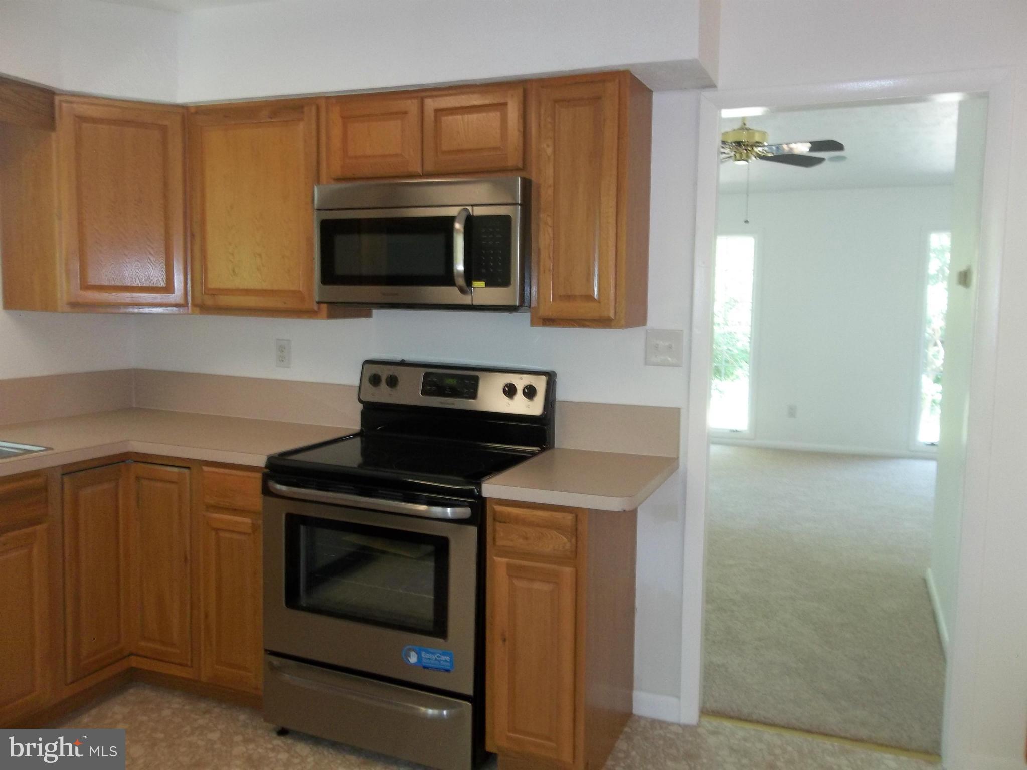 6038 Howellsville Road Front Royal, VA 22630 - Photo 18 of 30 a kitchen with a stove and a microwave