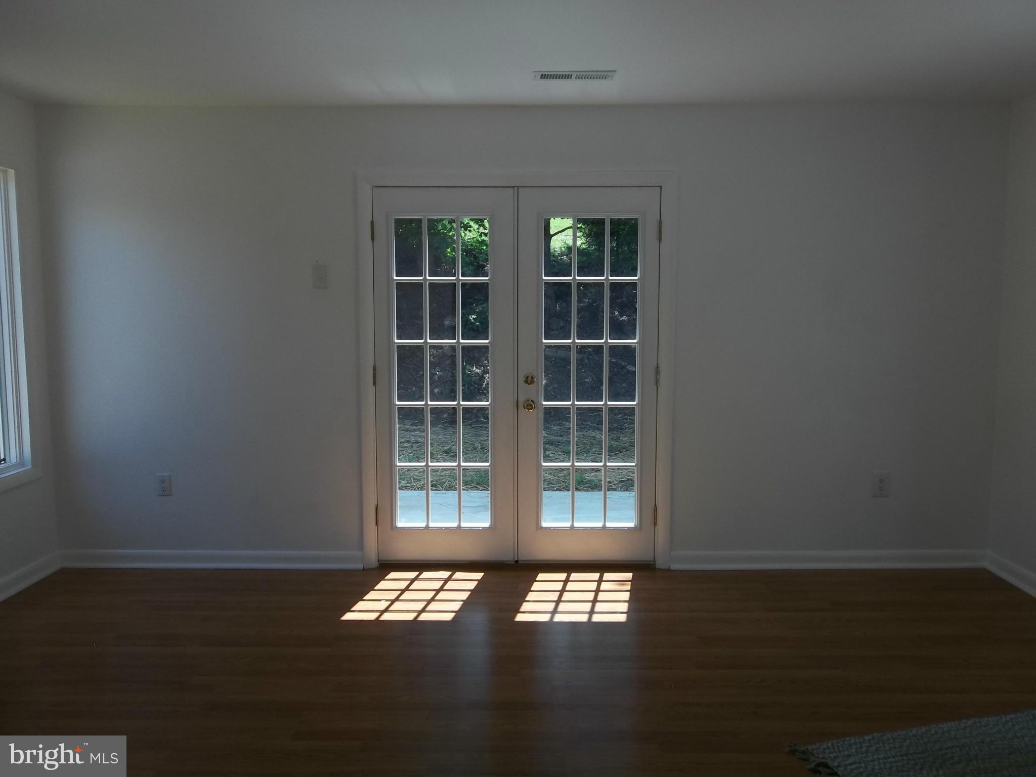 6038 Howellsville Road Front Royal, VA 22630 - Photo 21 of 30 an empty room with wooden floor and windows