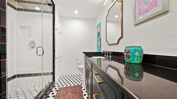 a bathroom with a mirror and a shower
