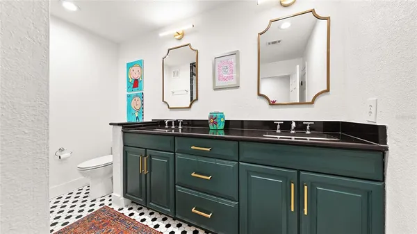 a bathroom with a sink vanity and a toilet