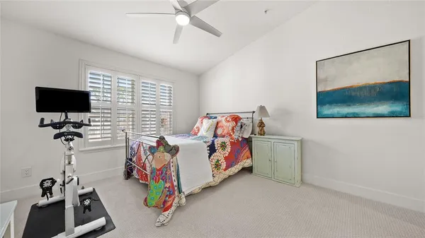 a bedroom with furniture and a flat screen tv