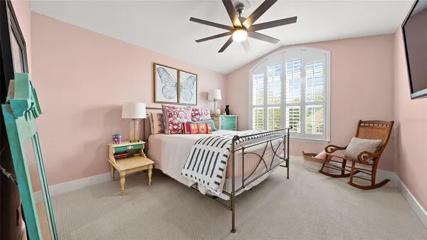 a bed sitting in a bedroom next to a window