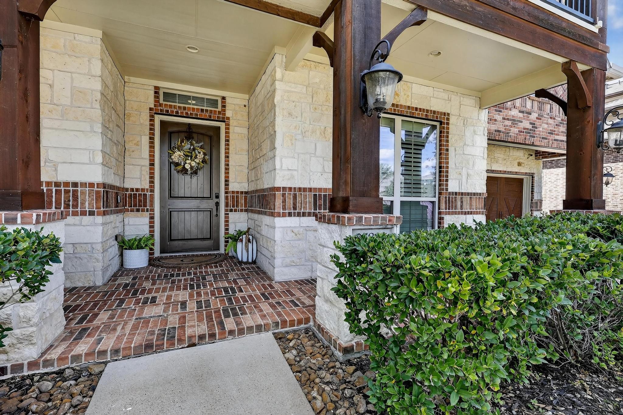 25803 Heritage Maple Drive Spring, TX 77389 - Photo 5 of 46 a view of a house with brick walls and a pathway