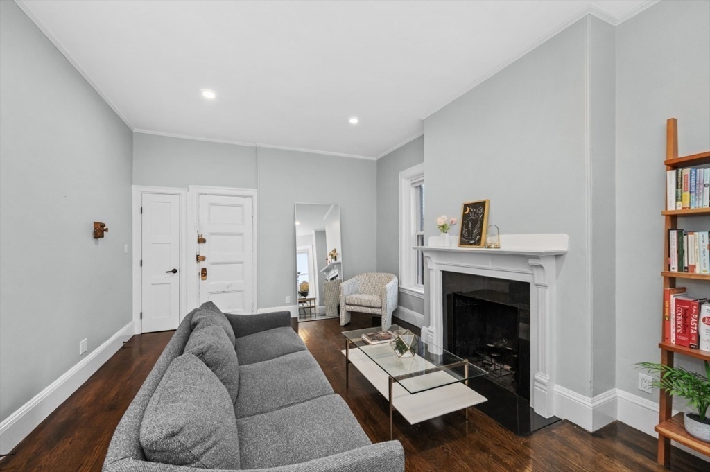 1880 Beacon Street, Unit 6 Brookline, MA 02445 - Photo 3 of 18 a living room with furniture and a fireplace