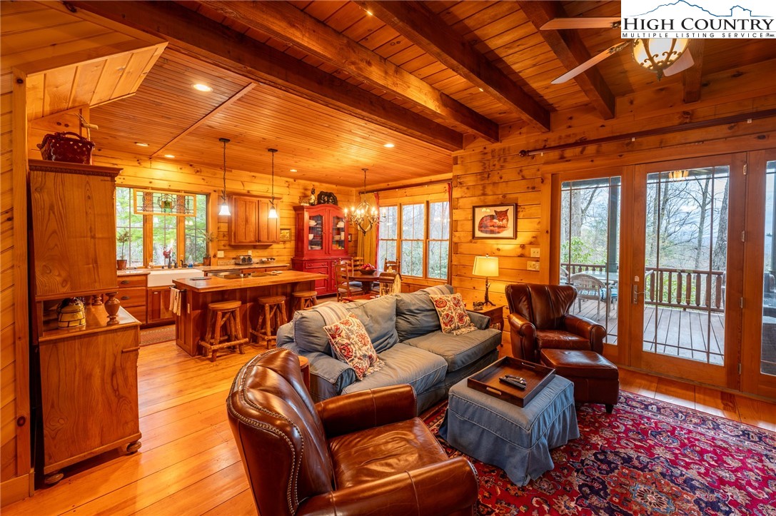 725 Fox Den Road Blowing Rock, NC 28605 - Photo 11 of 44 a living room with furniture a wooden floor and next to a window