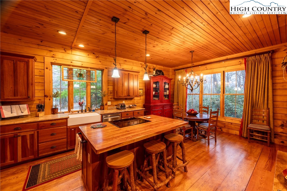 725 Fox Den Road Blowing Rock, NC 28605 - Photo 12 of 44 a dining room with furniture water view and large windows
