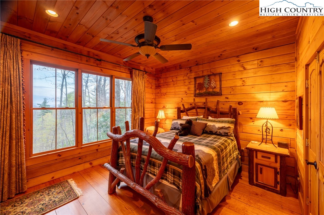 725 Fox Den Road Blowing Rock, NC 28605 - Photo 20 of 44 a bed room with a bed and a large window