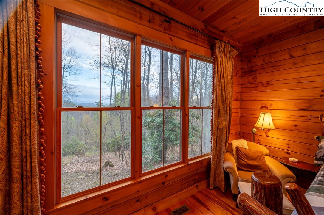 725 Fox Den Road Blowing Rock, NC 28605 - Photo 21 of 44 a view of a room with chair and a floor to ceiling window