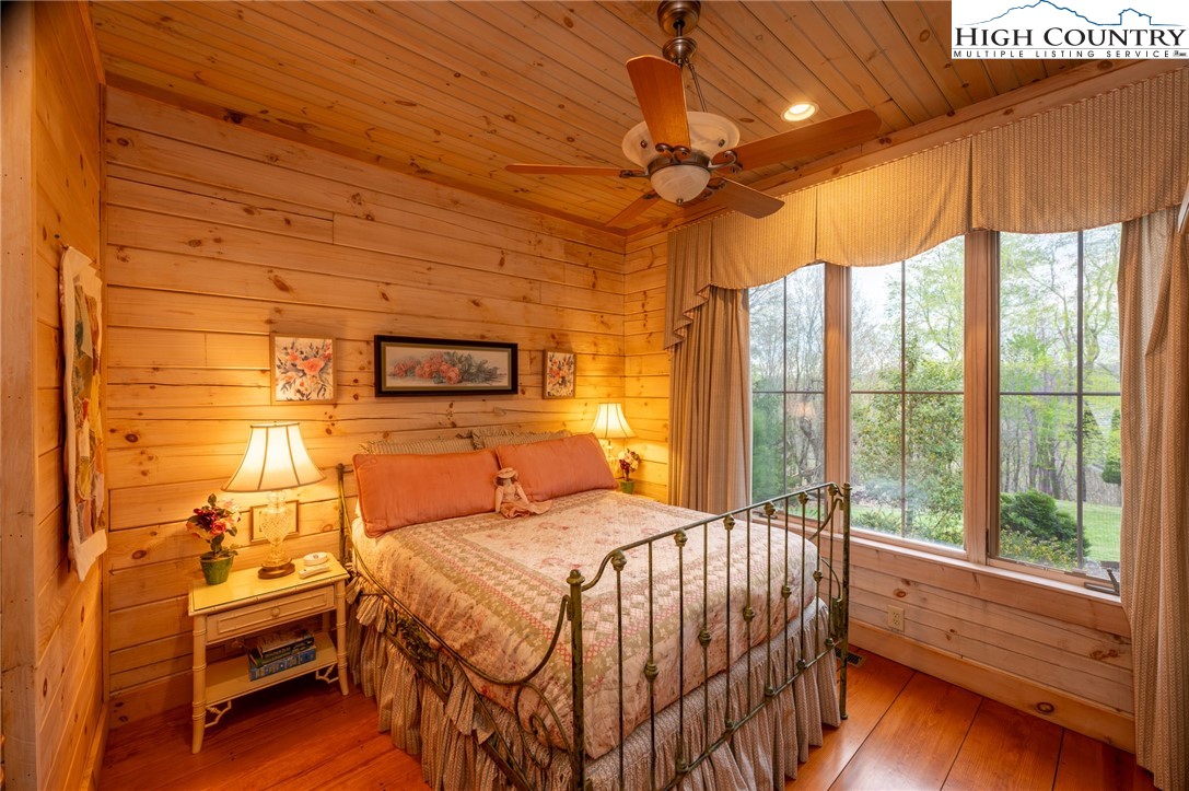 725 Fox Den Road Blowing Rock, NC 28605 - Photo 29 of 44 a bedroom with a bed and a large window with the outer view