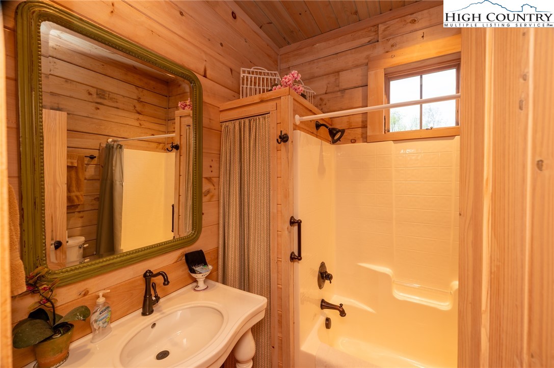 725 Fox Den Road Blowing Rock, NC 28605 - Photo 30 of 44 a bathroom with a sink and a mirror