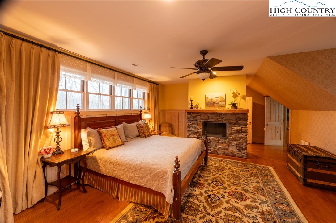 725 Fox Den Road Blowing Rock, NC 28605 - Photo 32 of 44 a bed room with a bed and a chandelier