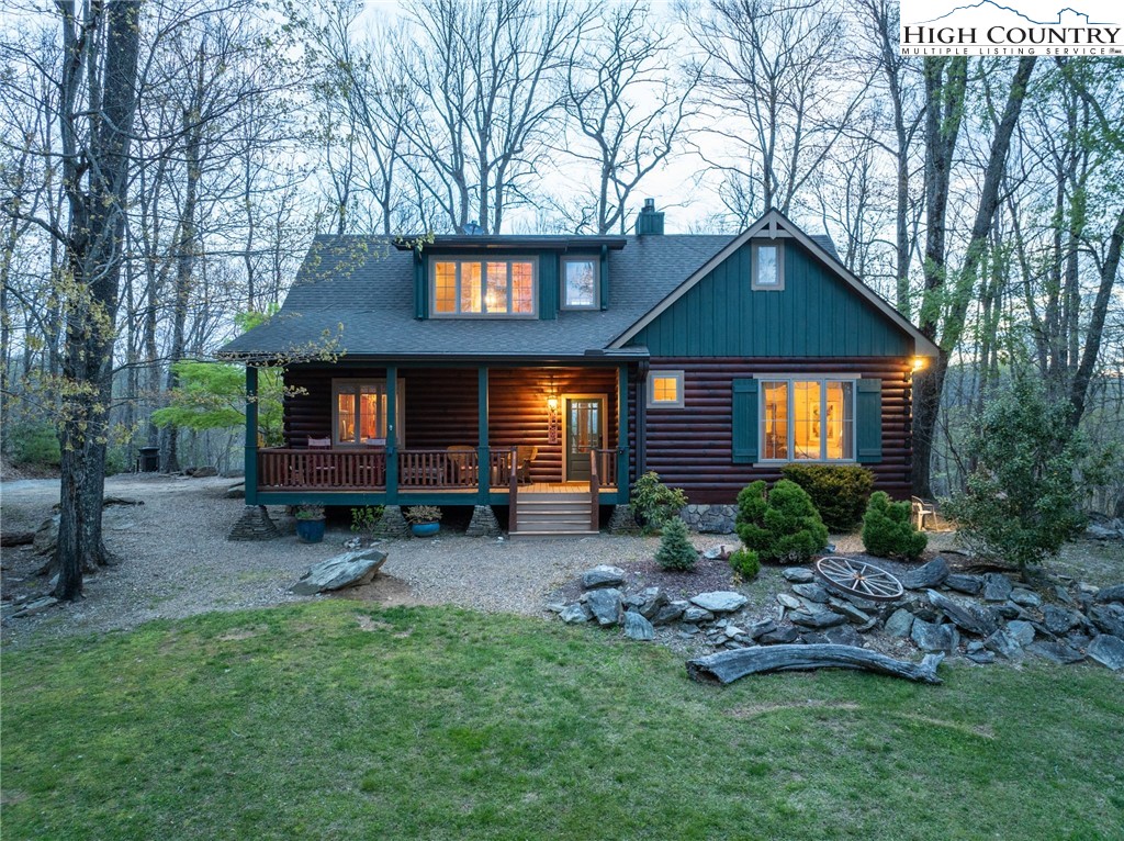 725 Fox Den Road Blowing Rock, NC 28605 - Photo 37 of 44 a front view of a house with a garden and trees