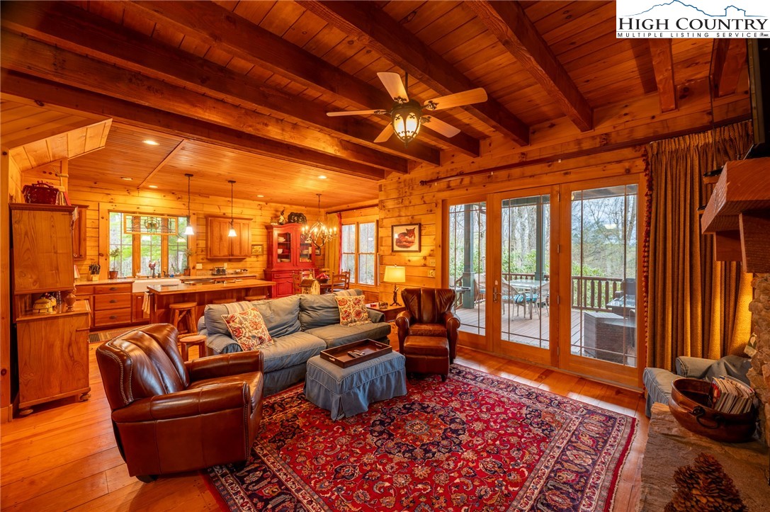 725 Fox Den Road Blowing Rock, NC 28605 - Photo 9 of 44 a living room with furniture a rug and a floor to ceiling window