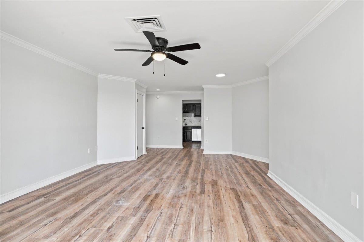 655 Riverside Drive, Unit 608B Memphis, TN 38103 - Photo 7 of 28 Wood-finish flooring, crown molding, ceiling fan, recessed lighting, and a neutral wall color