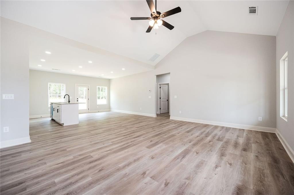 301 C W Sims Road Hiram, GA 30141 - Photo 11 of 29 a view of a kitchen with wooden floor and a ceiling fan