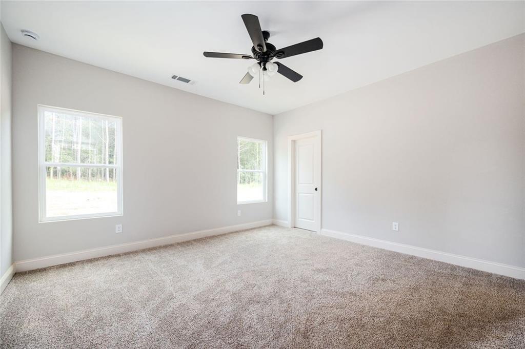 301 C W Sims Road Hiram, GA 30141 - Photo 15 of 29 an empty room with a window and a fan